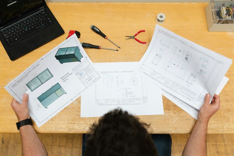 Engineering drawings and design calculations on a desk