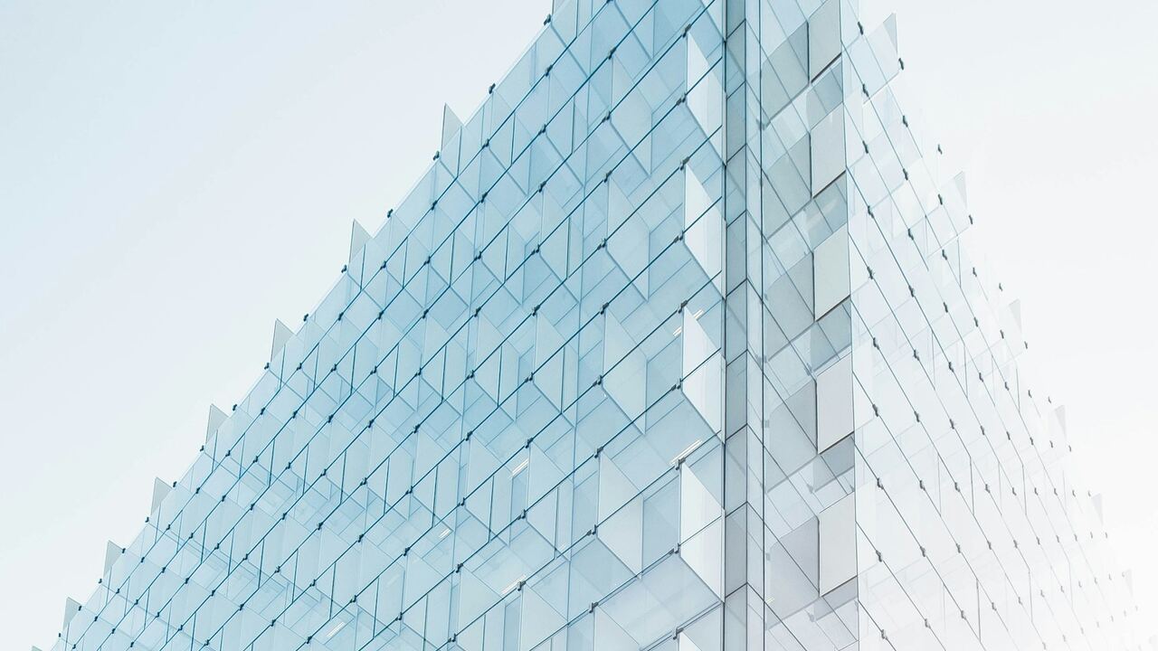 Modern glass and steel infrastructure against the sky