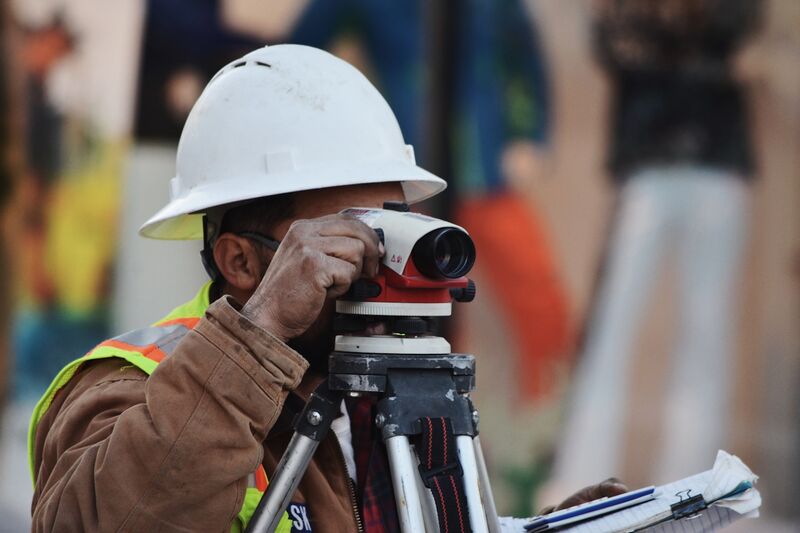 Engineer carrying out a site survey on a highway scheme